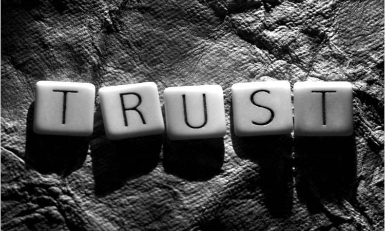 Scrabble tiles spelling "Trust"
