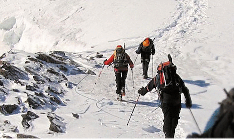Climbing and summiting a snow-covered mountain