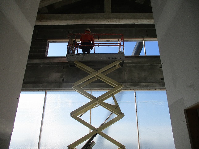 MM - Scissor lift in use per manufacturers instructions within the interior of the project
