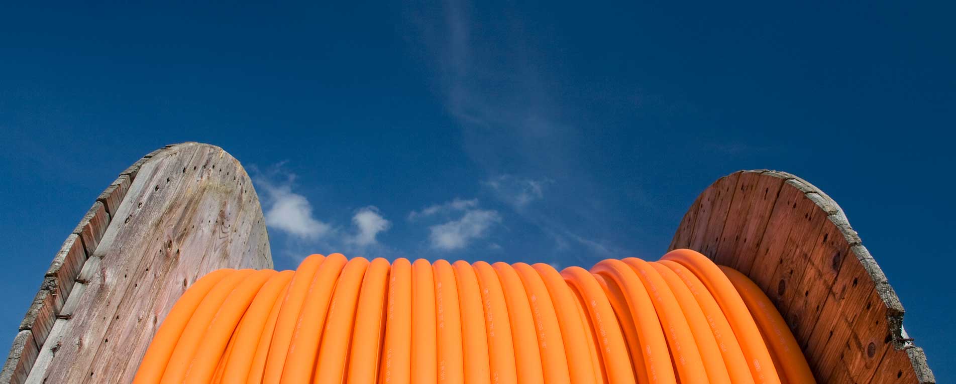 Reel of orange conduit for fiber optic cable