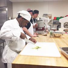 Chef Cutting Strawberries for Fast & Furious Forks Competition