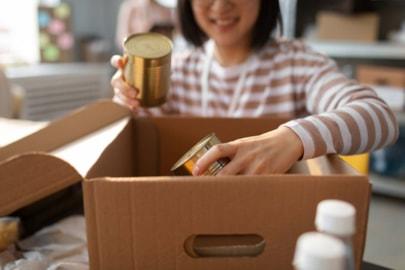 volunteer-putting-food-donations-box-charity