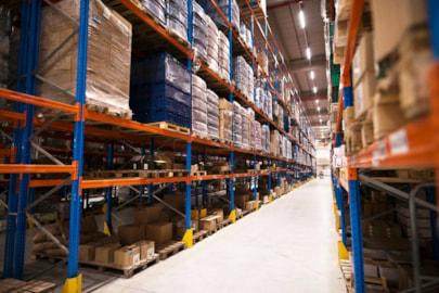 interior-large-distribution-warehouse-with-shelves-stacked-with-palettes-goods-ready-market